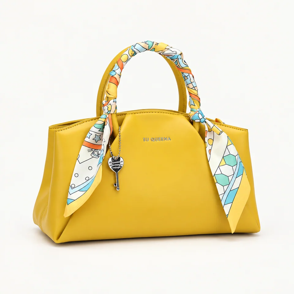 SU QUEENA3177 yellow bag with a patterned handle scarf and key charm, isolated on off-white.